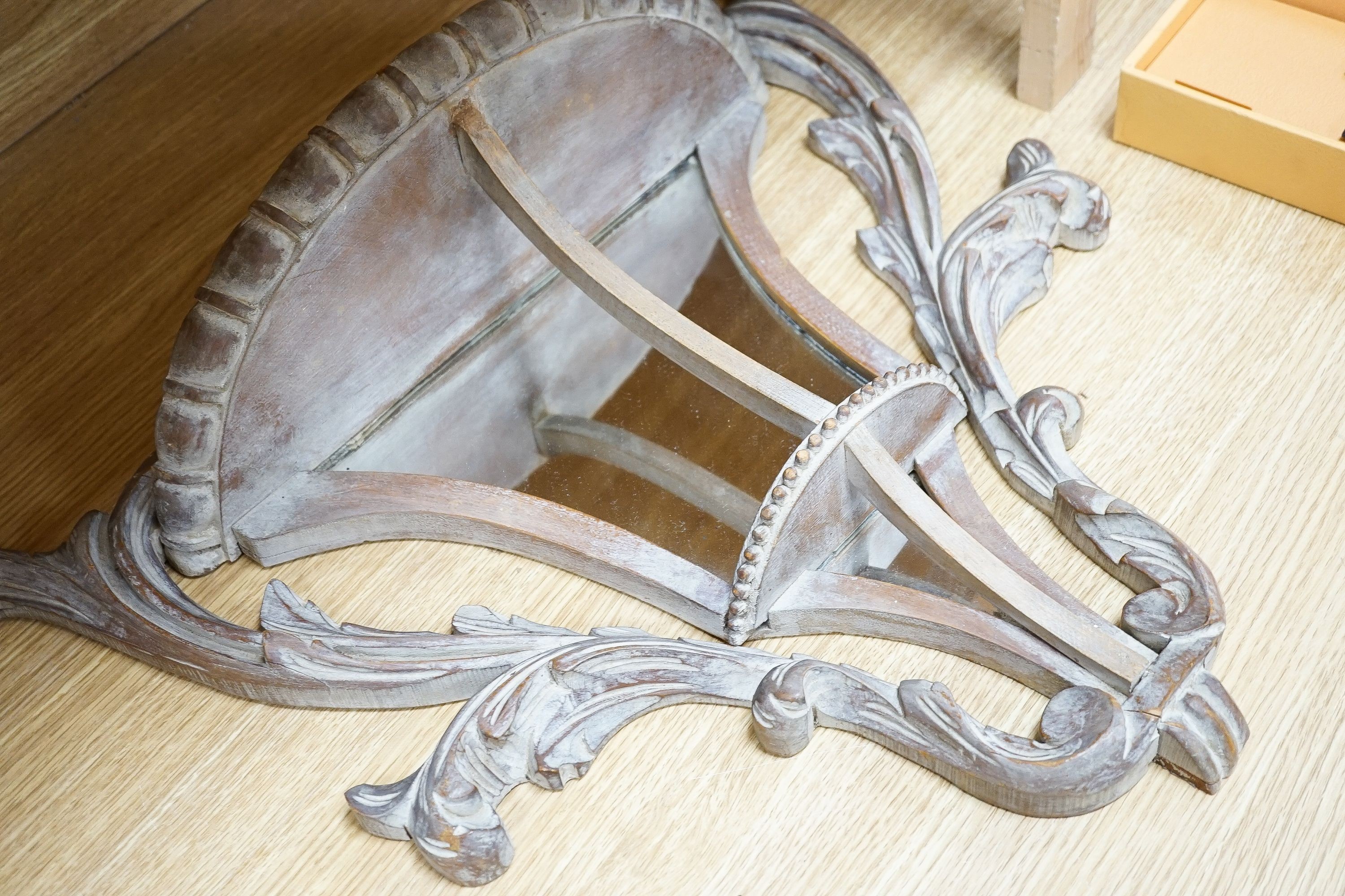 A pair of early 20th century mirror backed carved beech wall brackets 50cm